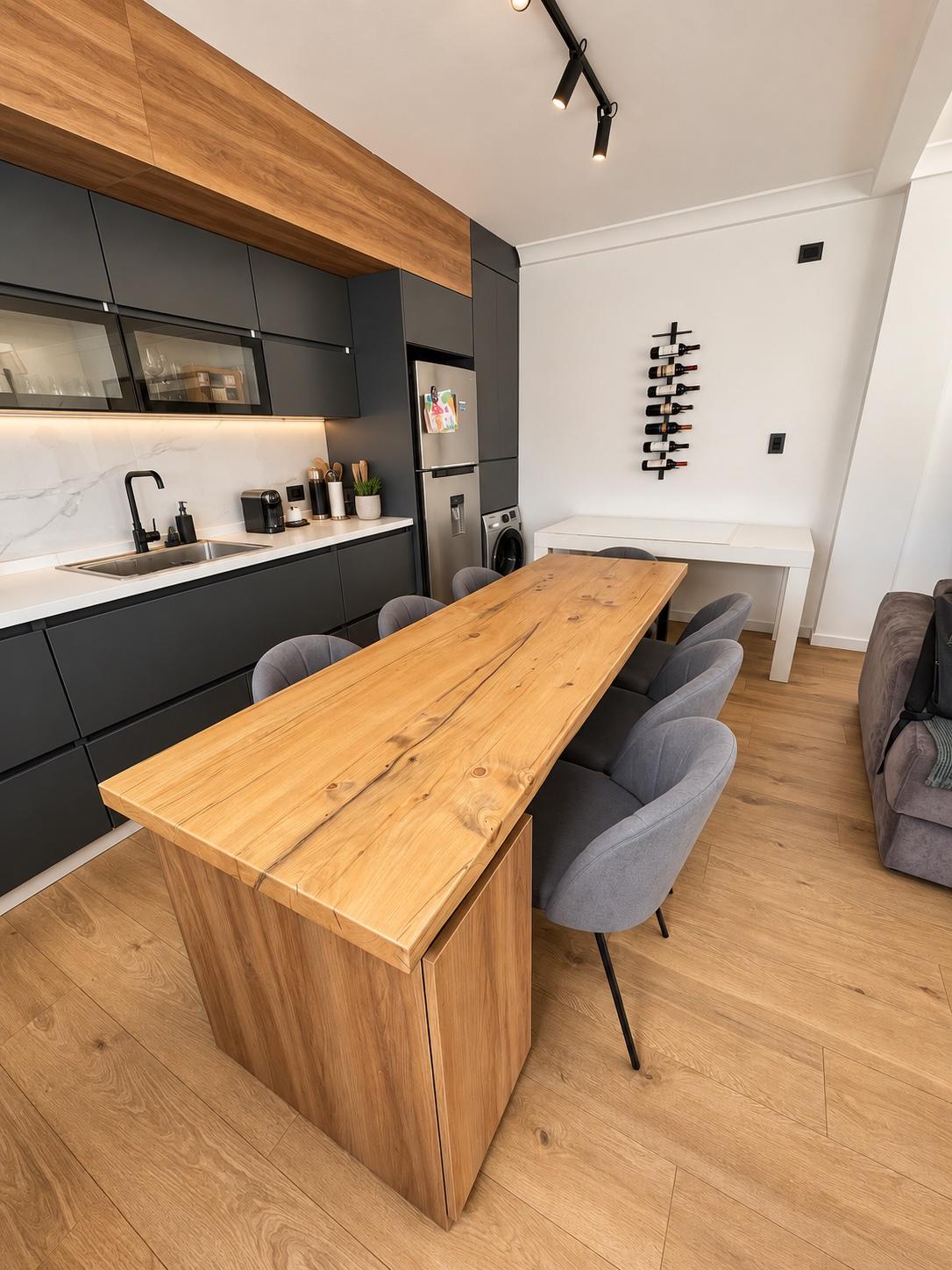 Mesa de comedor en madera maciza con base-mueble y guardado oculto para el cesto de residuos